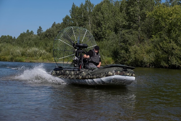 Highspeed riding in an airboat on the river on a summer day with splashes and waves