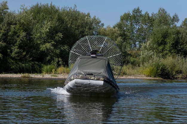 Highspeed riding in an airboat on the river on a summer day with splashes and waves