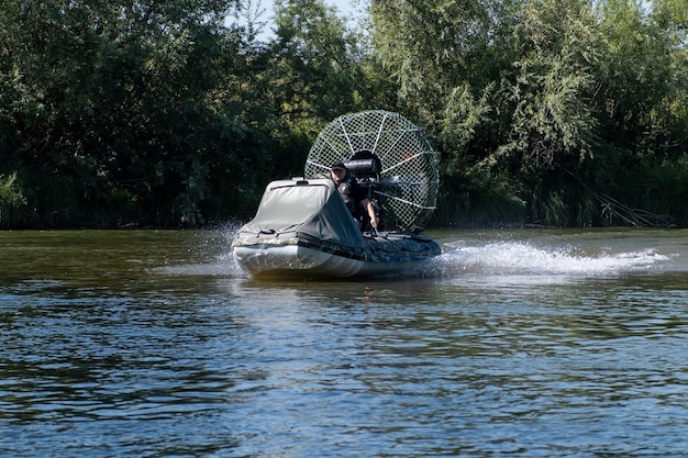 Highspeed riding in an airboat on the river on a summer day with splashes and waves