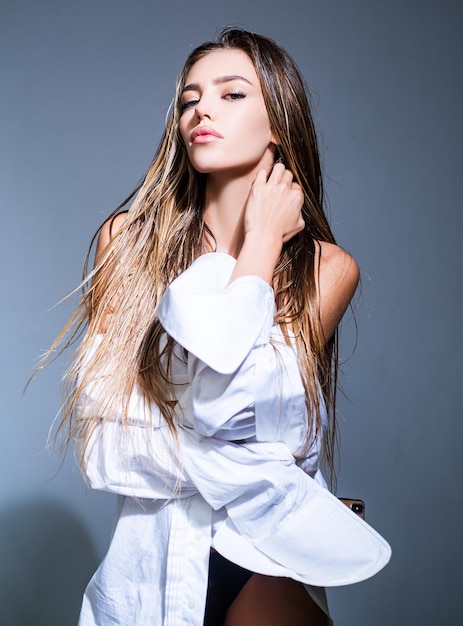 Hight fashion Glamour portrait of pretty beautiful fashion woman in white shirt posing in studio