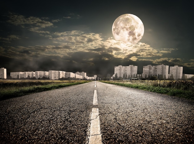 Highway to district under the moon. Elements of this image furnished by NASA