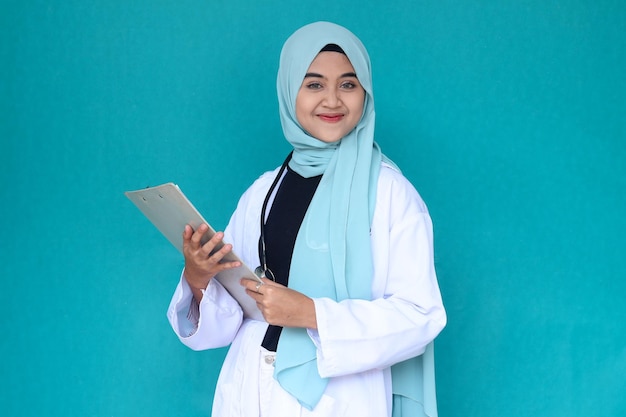 Hijab female doctor in white medical gown and stethoscope hold clipboard with medical documents