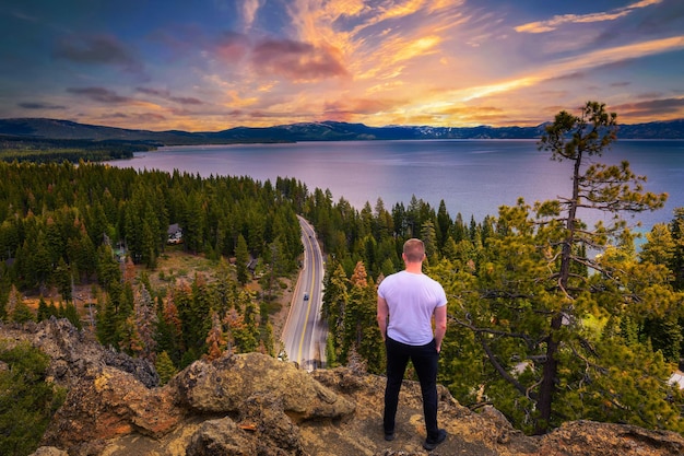 Hiker enjoying sunset over lake tahoe from the eagle rock in california