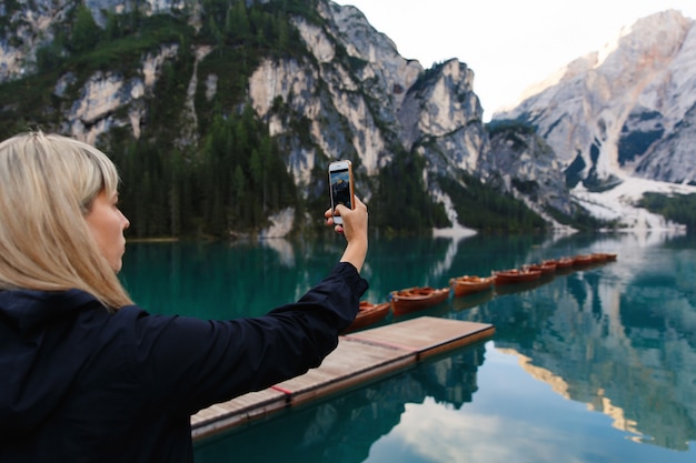 Photo hiker makes photo of beautiful landscape on smartphone