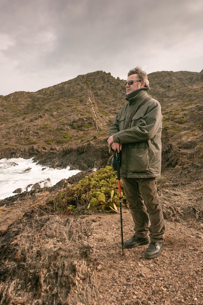 A hiker makes a stop to contemplate the sea