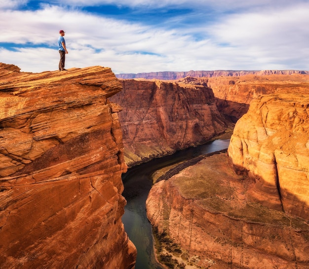 Hiker standing at the edge of horseshoe bend