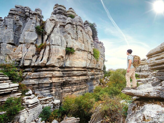 Hiker standing on a rock looking out over a rocky landscape Man hiking Torcal de Antequera in Spain