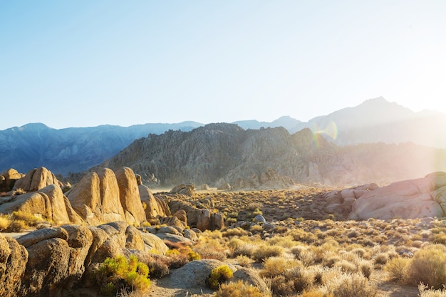 Hiker in unusual stone formations in Alabama hills, California, USA