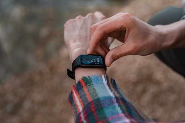 Hiker using heart rate monitor training running smartwatch checking performance or gps