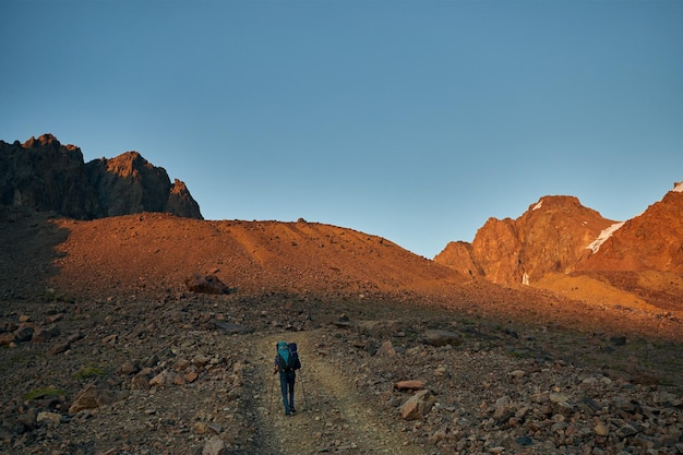 Hiker with backpack in the mountains