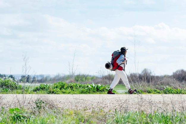 Hiker woman with backpack walking. travel concept