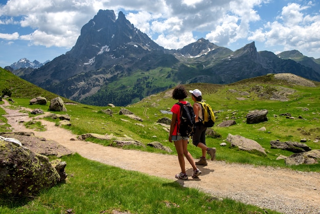 Hiker women in the path of the French Pyrenees mountains