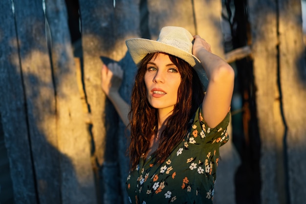 Hiker young woman hiking in the countryside at sunset