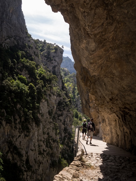 hikers walking among the mountains of Asturias. Crossing a bridge.