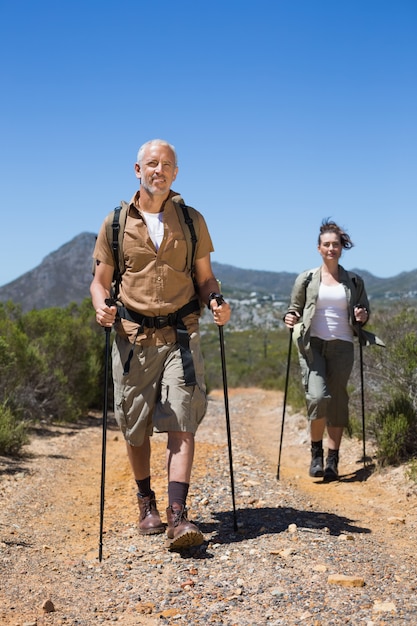 Hiking couple walking on mountain trail