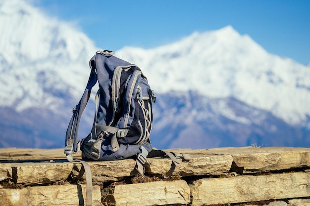 A hiking gray backpack on the background of the mountains in Nepal.