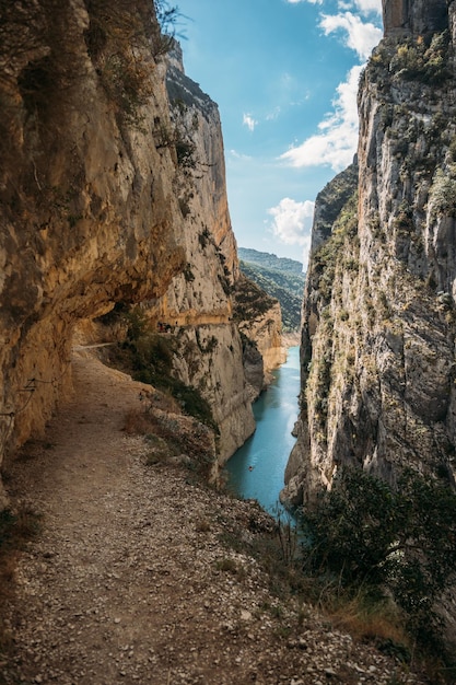 Hiking on Great Route Footpath carved on the rock of Montrebei Gorge or Congost de Montrebei, Spain