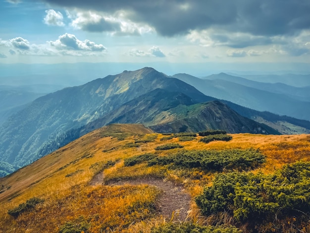 Hiking tourist trail in high mountains blue sky