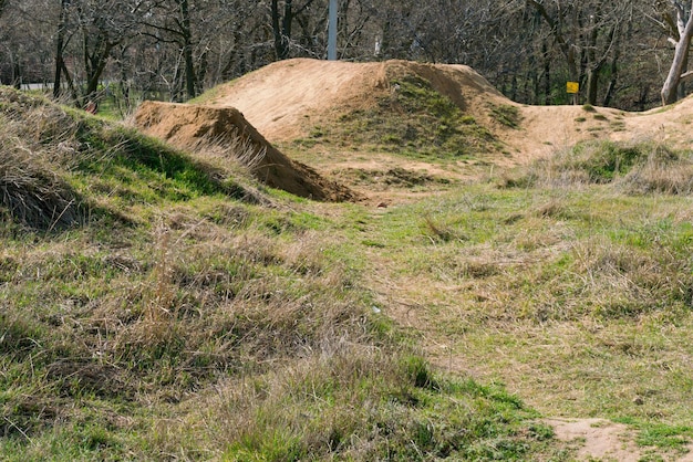 Hills are on track for making bicycle tricks Empty Shape Bike Outdoors Background Mountain No People Risk Safety Transport Transportation Stunt Tire Biker Danger Grass Day Road