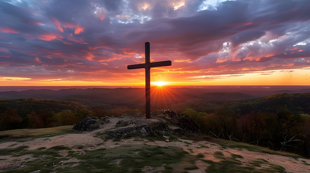 Hilltop cross silhouette against vibrant sunset backdrop