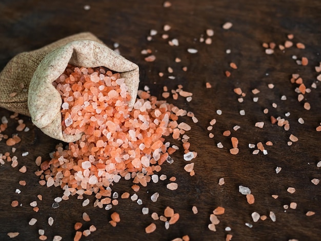 Himalaya Salt in Hemp sack on Wooden BackgroundPink Salt Raw FoodRaw Food Ingredients Salty for Cooking and Aroma TherapyFood for Good Health concept