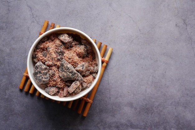 Himalayan black salt rock crystals Kala Namak in a container on table