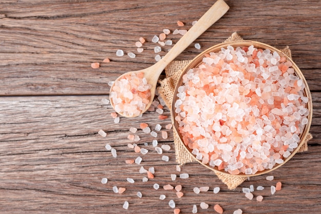 Himalayan pink salt crystals on wooden board, scrub spa therapy healthy