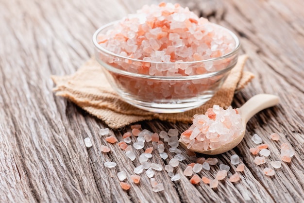 Himalayan pink salt crystals on wooden board