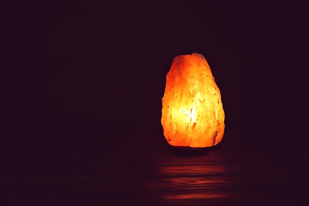 Himalayan salt lamp on black background