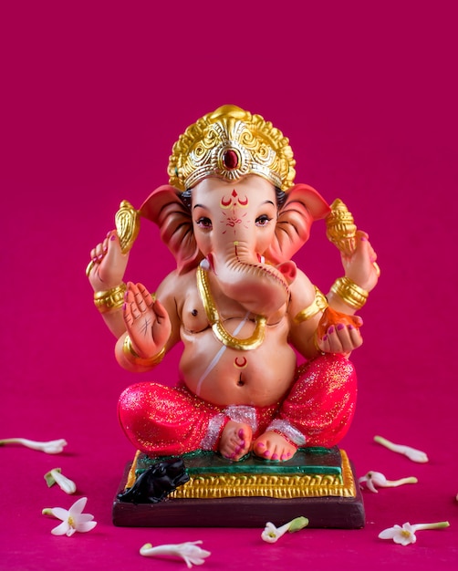 Hindu God Ganesha. Ganesha Idol on pink.