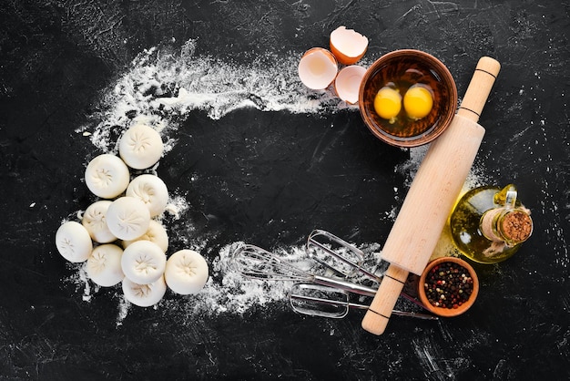 Hinkali Homemade Flour eggs dough on a black background Top view Free copy space