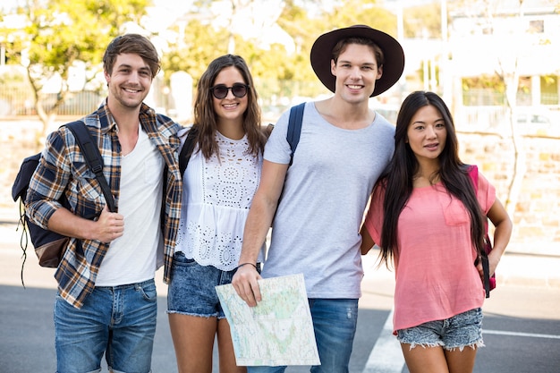 Hip friends smiling at the camera outdoors