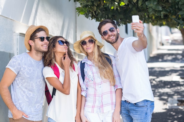 Hip friends taking selfie on the street