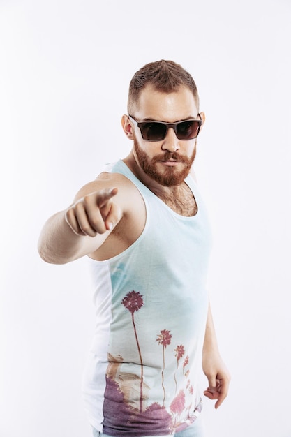 Hipster bearded redhead guy pointing index finger the front of him to the camera on white background