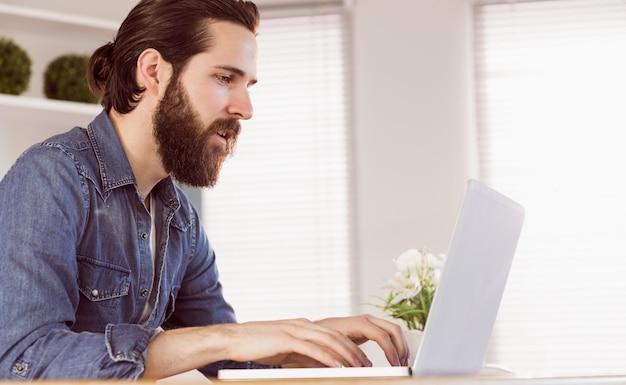 Hipster businessman working at his desk