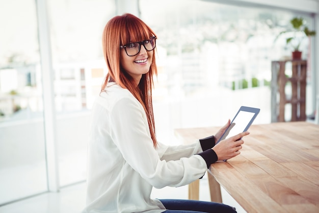 Hipster businesswoman using her tablet