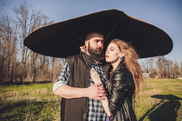 Hipster couple girl with red hair and shaved bearded man