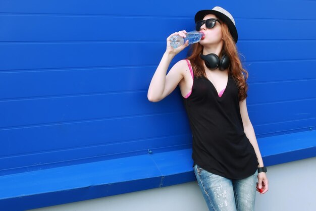 Hipster girl at the blue wall