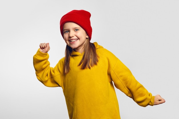 Hipster girl does lucky dance raises hands up in hooray feels like champion