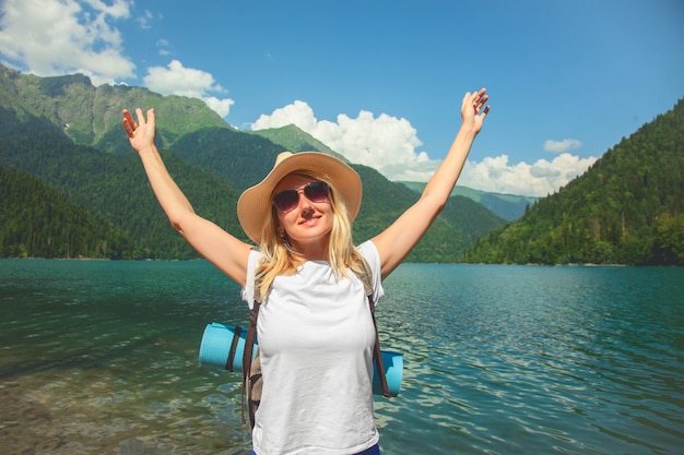 A hipster girl in a hat travels in the mountains The girl loves to travel.