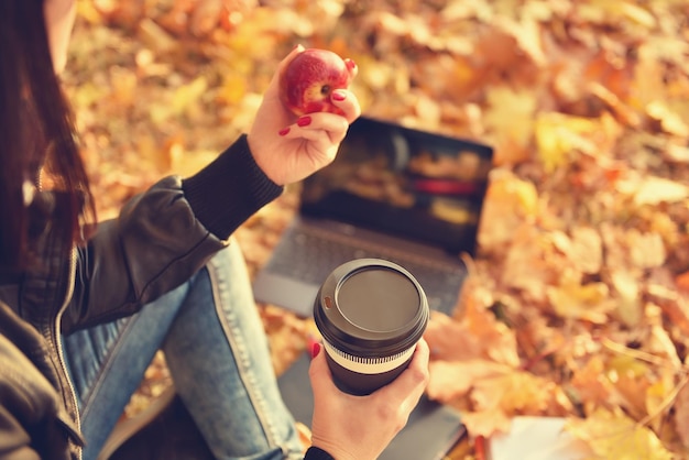 Hipster girl with coffee cup and apple