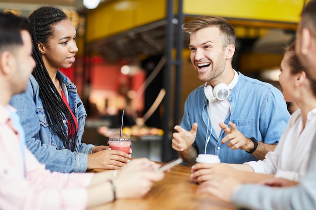 Hipster man telling story to friends