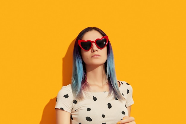 Hipster woman with blue hair wearing sunglasses Serious caucasian girl looking up Spring summer fashion sale