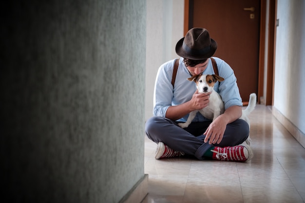 hipster young man posing with jack russell dog