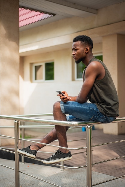 Hipster, a young man using a smartphone