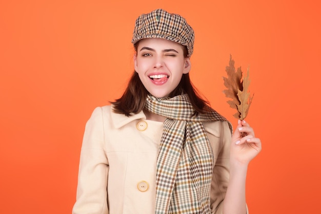 Hipster young woman in trendy autumn fall outfit stylish hat and scarf beauty girl hold autumn