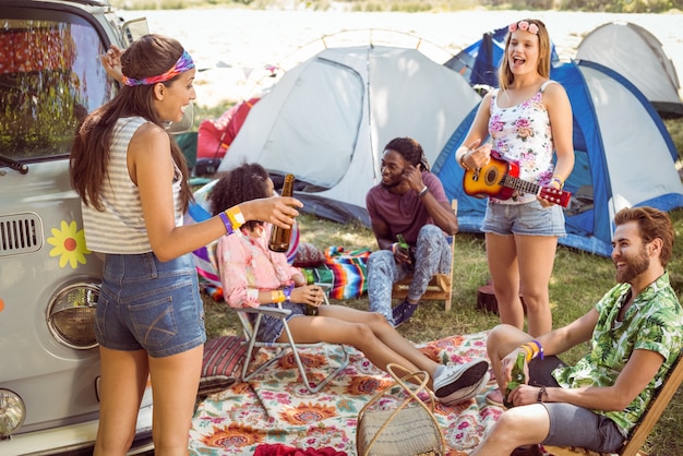 Hipsters having fun in their campsite