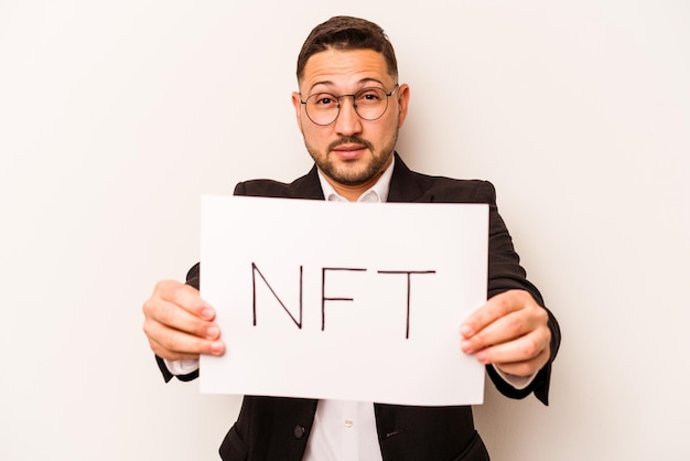 Hispanic business man holding a nft placard isolated on white background