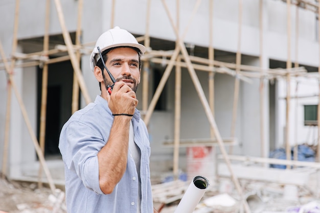 Hispanic latin indian builder work in construction site Architect home project chief engineer with floor plan