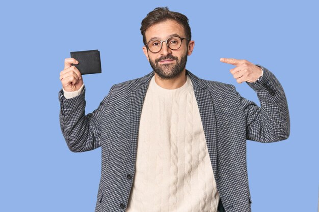 Hispanic male businessman holding wallet in studio